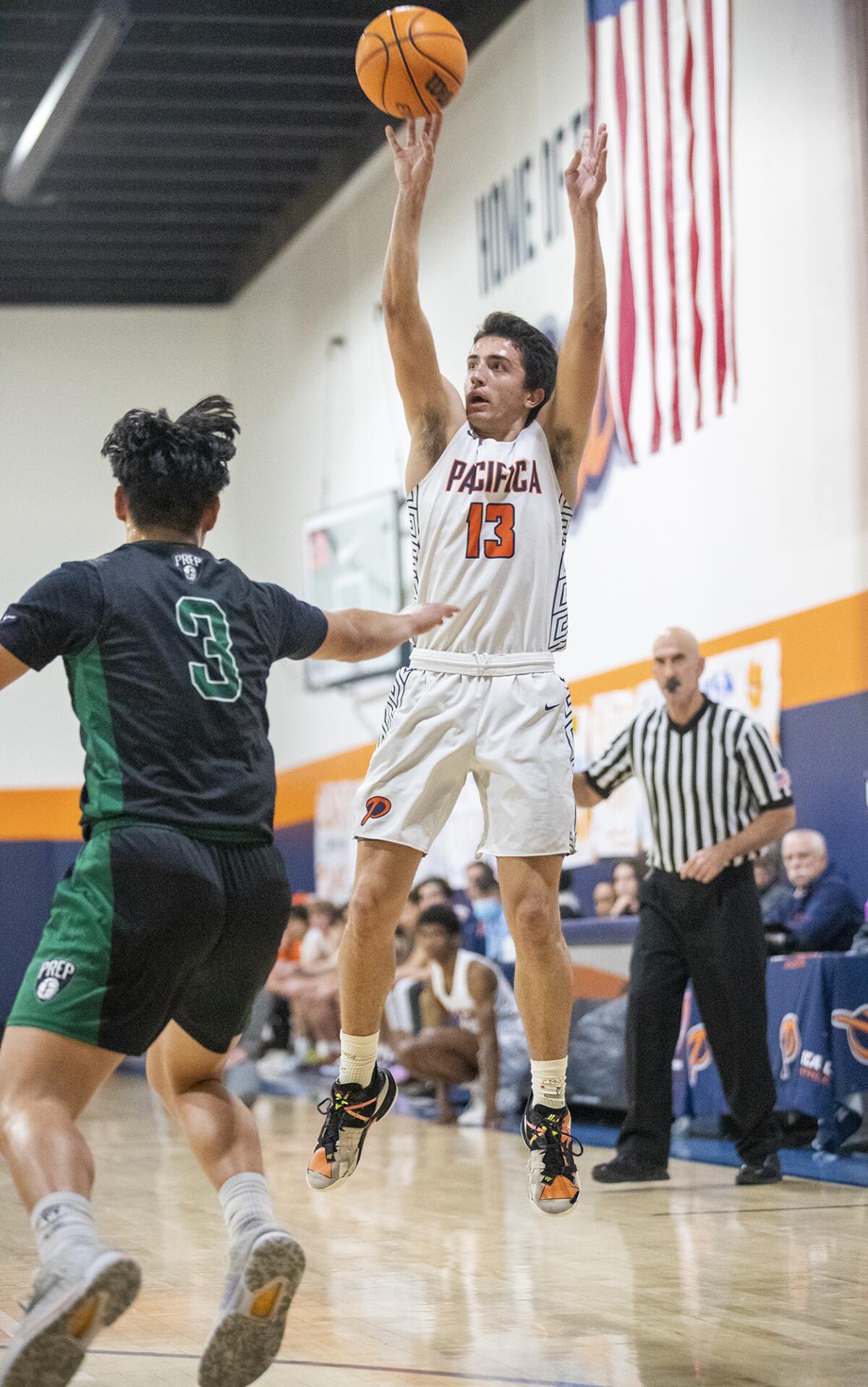 Pacifica Christian Orange County's Tanner Deal takes a shot over Fairmont Prep's Myles Che during a San Joaquin League game.
