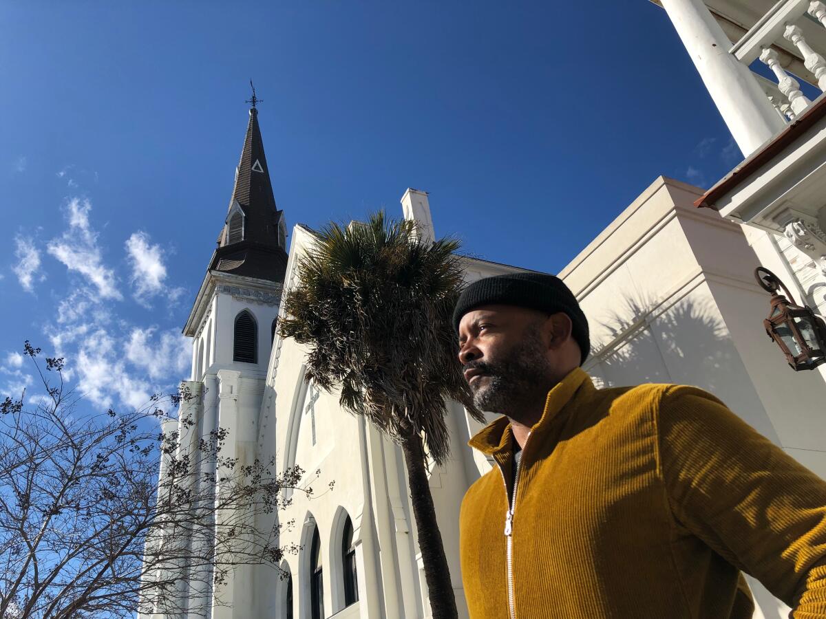Tyrone Beason stands in front of a church