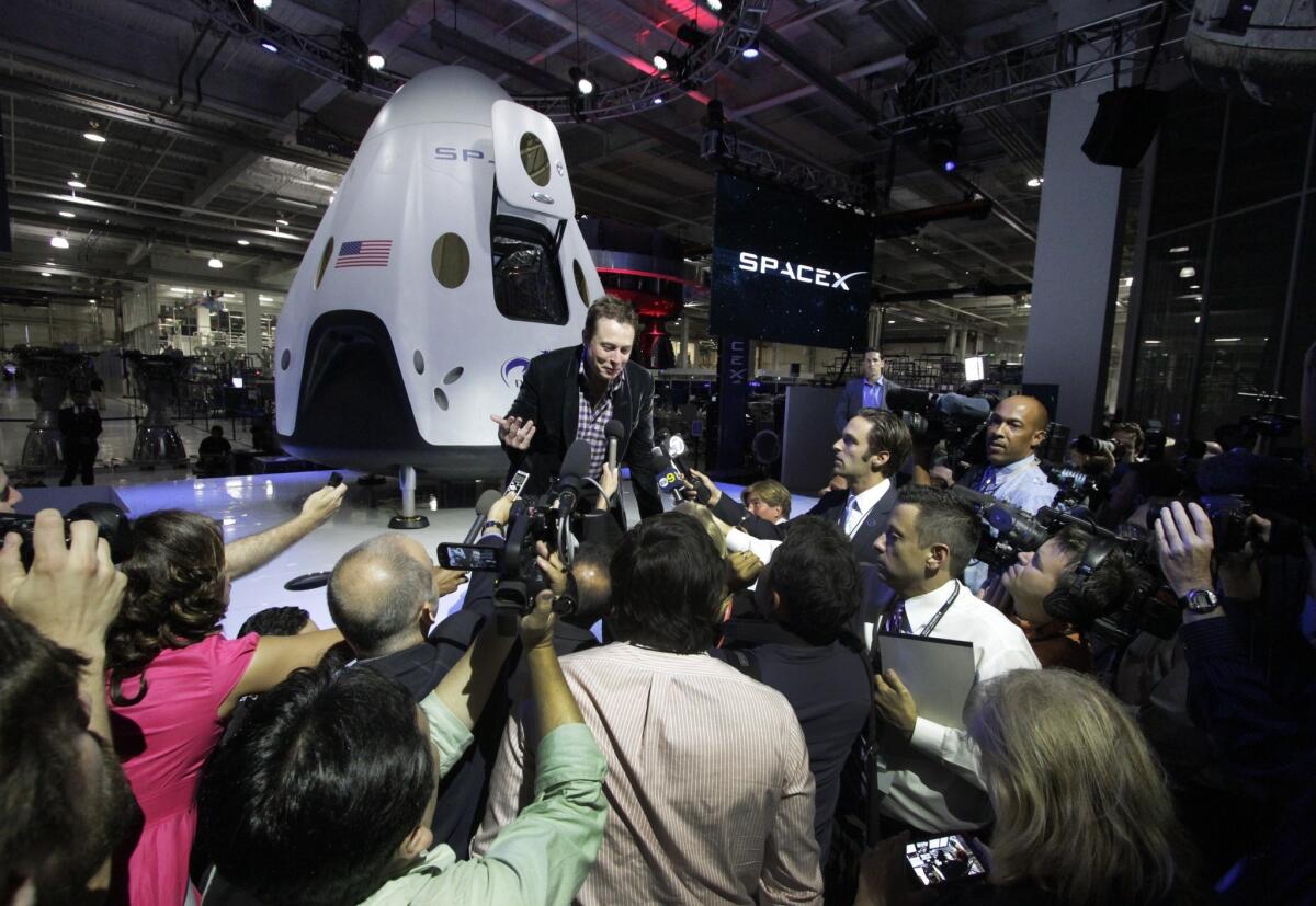SpaceX Chief Executive Elon Musk responds to the media Thursday evening after introducing the Dragon V2 capsule. "We wanted to take a big step in technology," Musk says. "It really takes things to the next level."