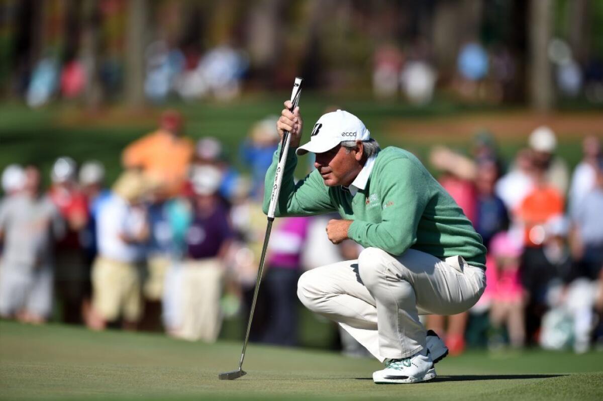 Fred Couples lines up a putt Thursday during the first round of the 78th Masters Golf Tournament at Augusta National Golf Club.