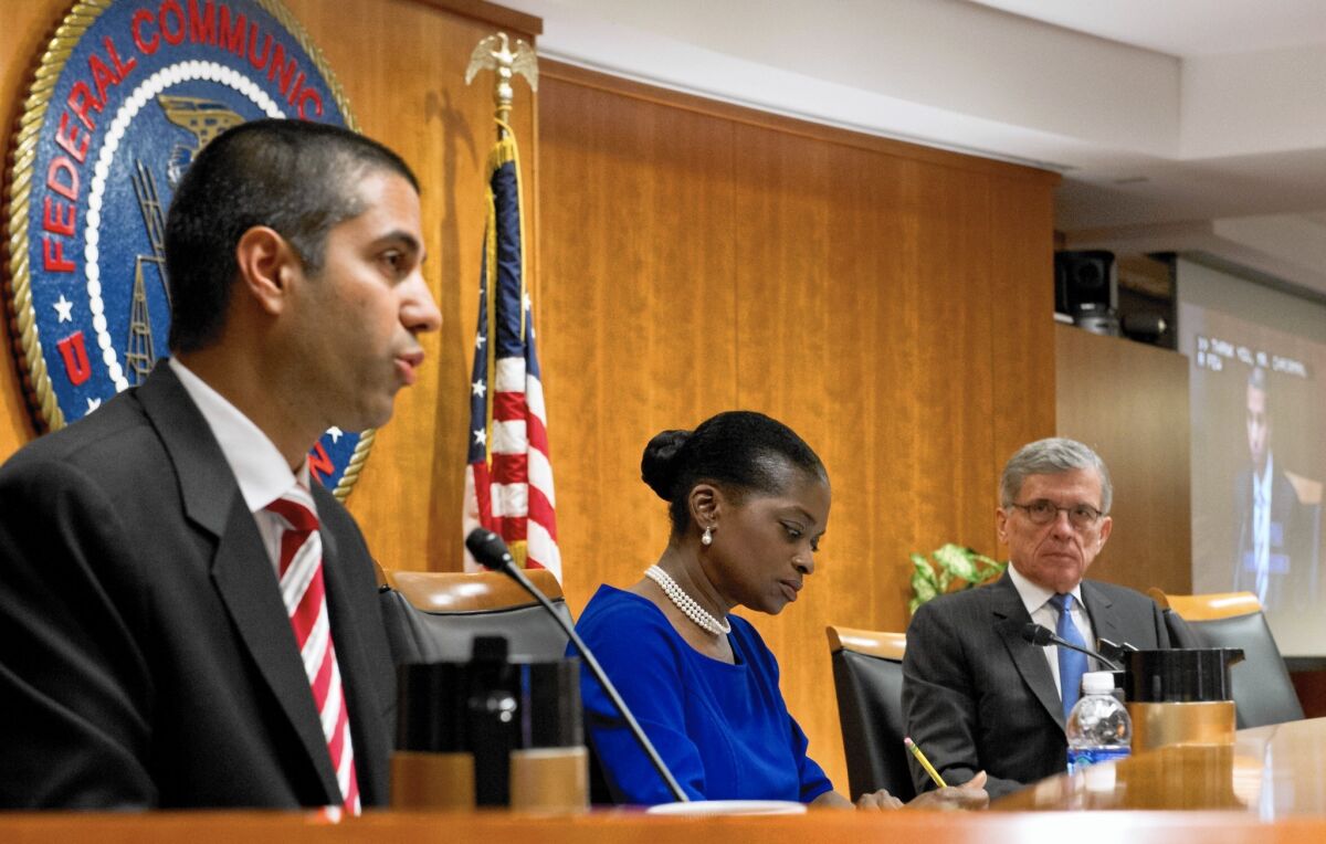 “Litigants are already lawyering up to seek judicial review of these new rules,” said FCC Commissioner Ajit Pai, left. With him are Commissioner Mignon Clyburn, center, and Chairman Tom Wheeler.