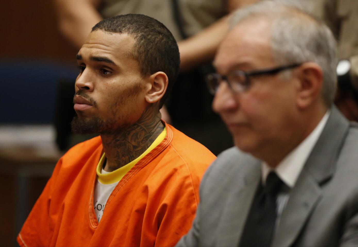 Forced to wear an orange jumpsuit to court, Chris Brown was ordered by a Los Angeles County judge to stay in jail without bail until April 23, pending a hearing to determine whether he violated terms of his probation.