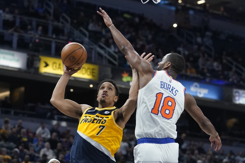 Indiana Pacers' Malcolm Brogdon (7) shoots against New York Knicks' Alec Burks (18) during the second half of an NBA basketball game Wednesday, Dec. 8, 2021, in Indianapolis. (AP Photo/Darron Cummings)