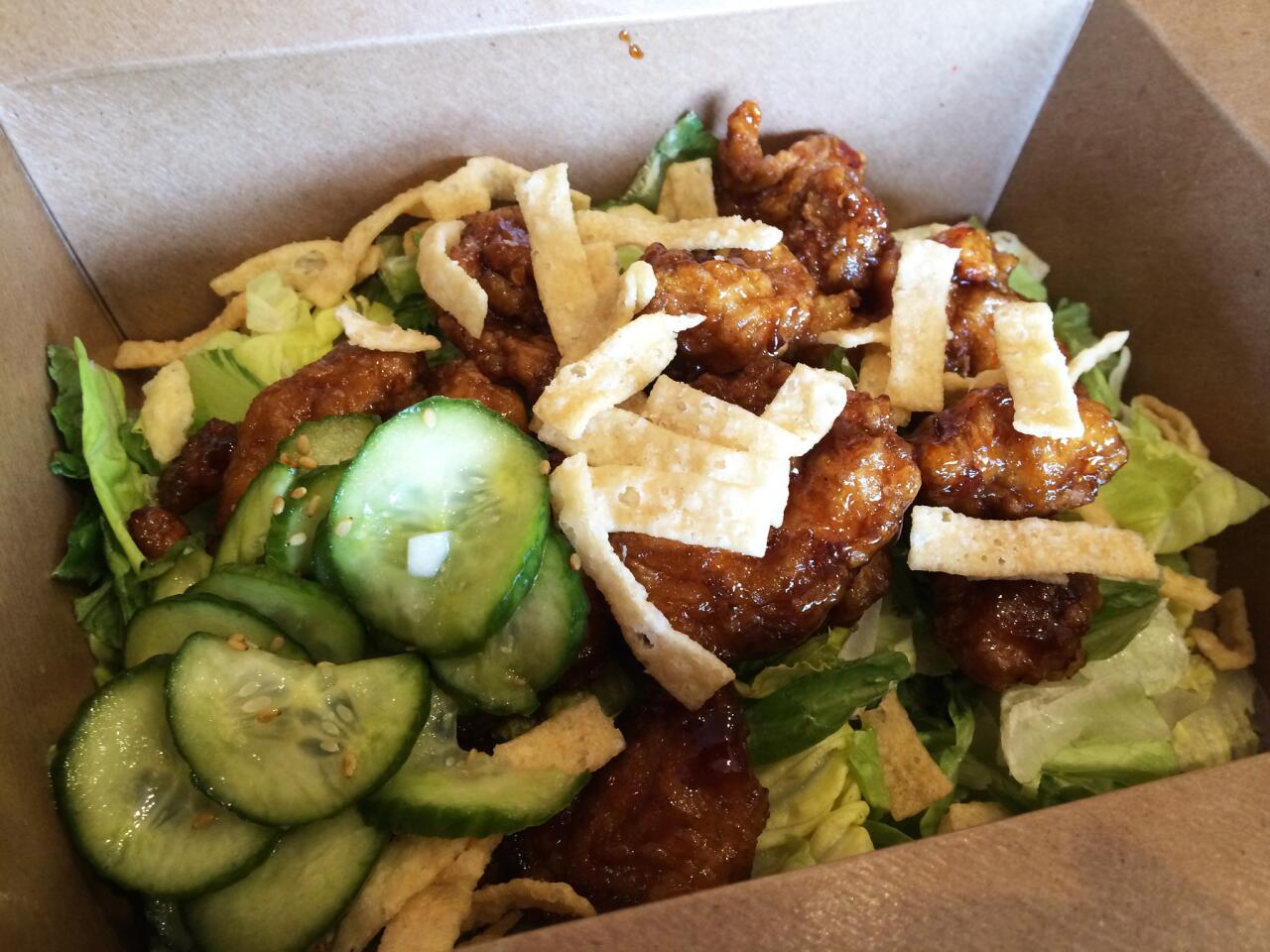 Orange chicken salad with pickled cucumbers, shallots, crispy wontons on lettuce with citrus vinaigrette.
