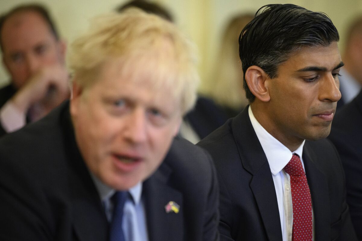 Britain's Chancellor Rishi Sunak, right, listens as Britain's Prime Minister Boris Johnson addresses his Cabinet during his weekly Cabinet meeting in Downing Street on Tuesday, June 7, 2022 in London. Johnson was meeting his Cabinet and trying to patch up his tattered authority on Tuesday after surviving a no-confidence vote that has left him a severely weakened leader. (Leon Neal/Pool Photo via AP)