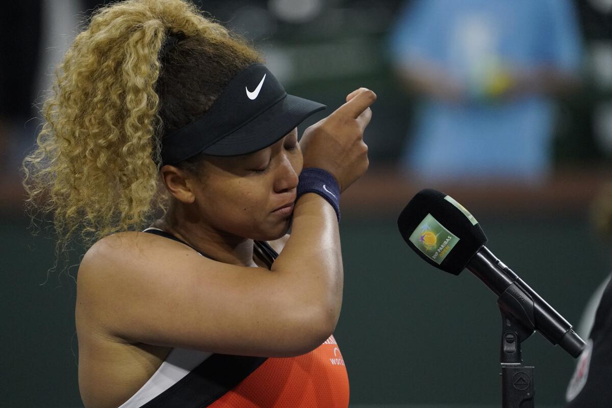 Naomi Osaka holds back tears as she speaks to the crowd after losing her match to Veronika Kudermetova.