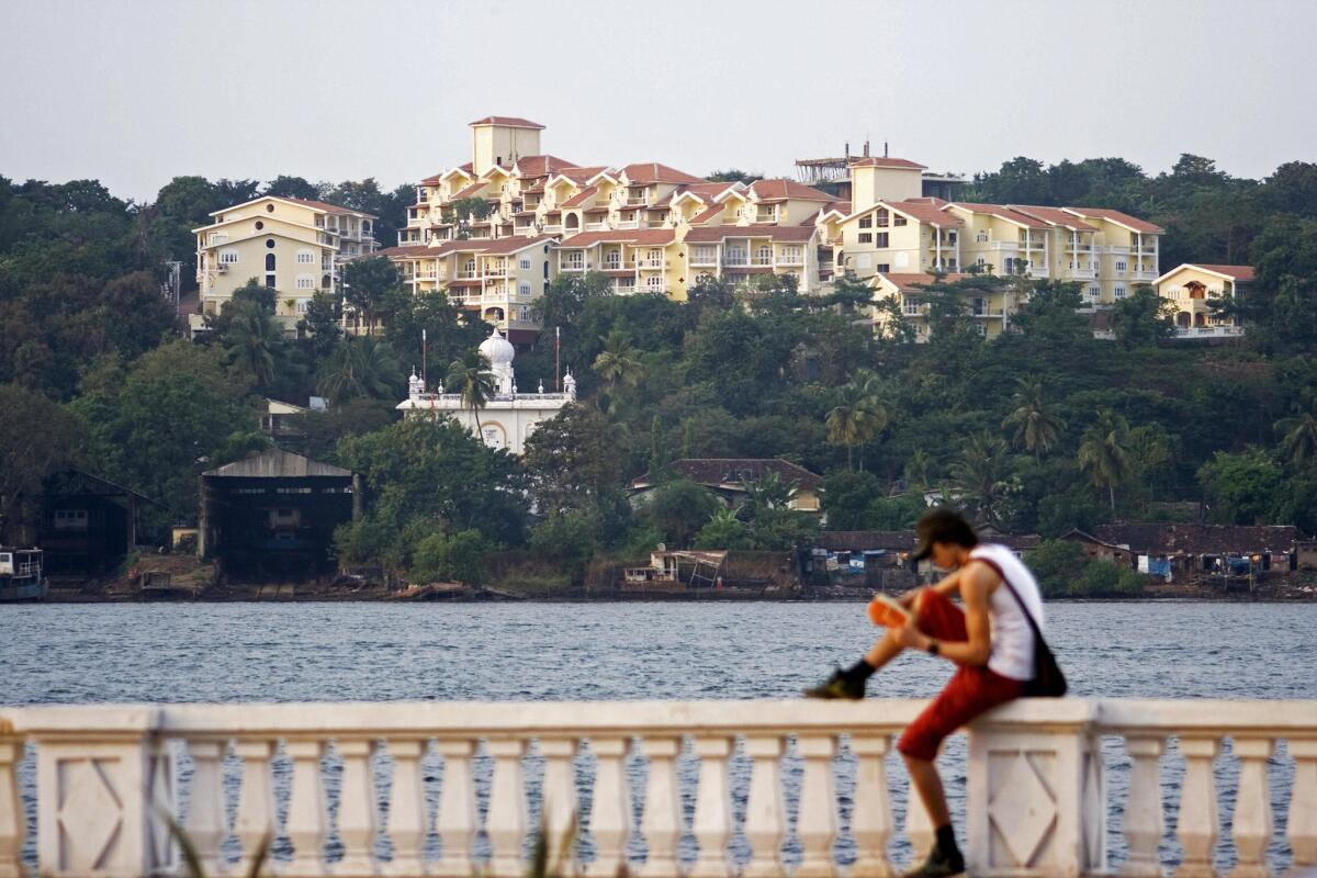A tourist rests on the banks of the Mandovi River in Panaji, capital of India's Goa state.