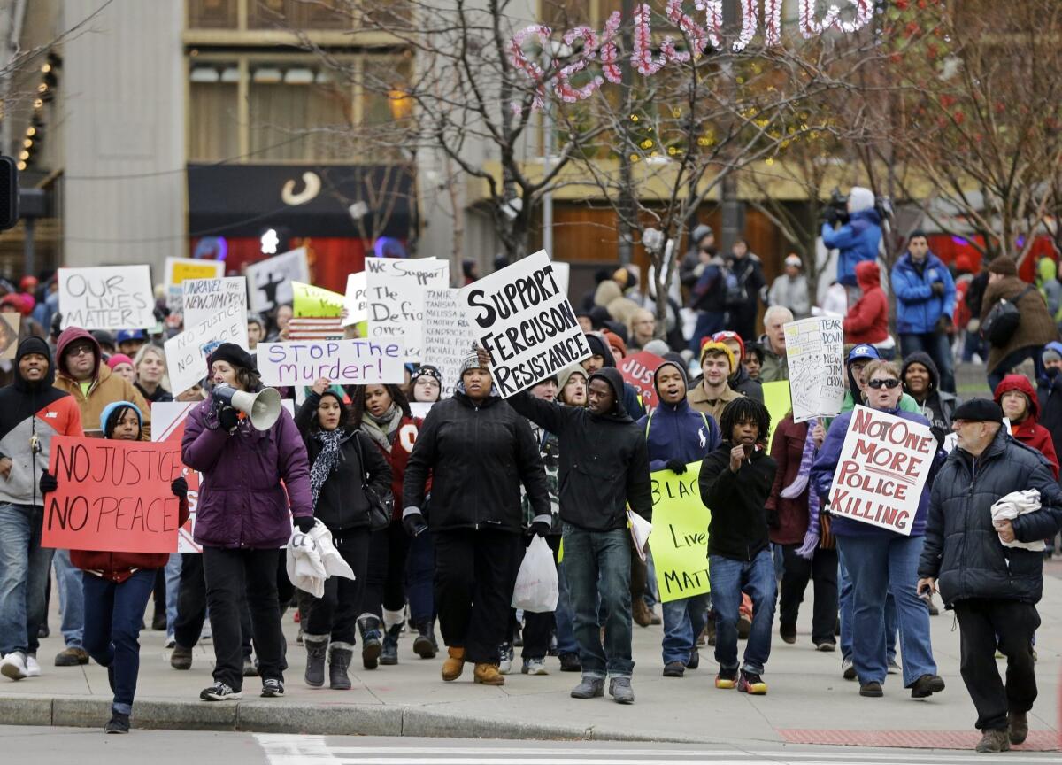 Demonstrators march toward Public Square in Cleveland Tuesday, Nov. 25, 2014, to protest over the weekend police shooting of Tamir Rice. The 12-year-old was fatally shot by a Cleveland police officer Saturday after he reportedly pulled a replica gun at the city park. (AP Photo/Mark Duncan) The Associated Press