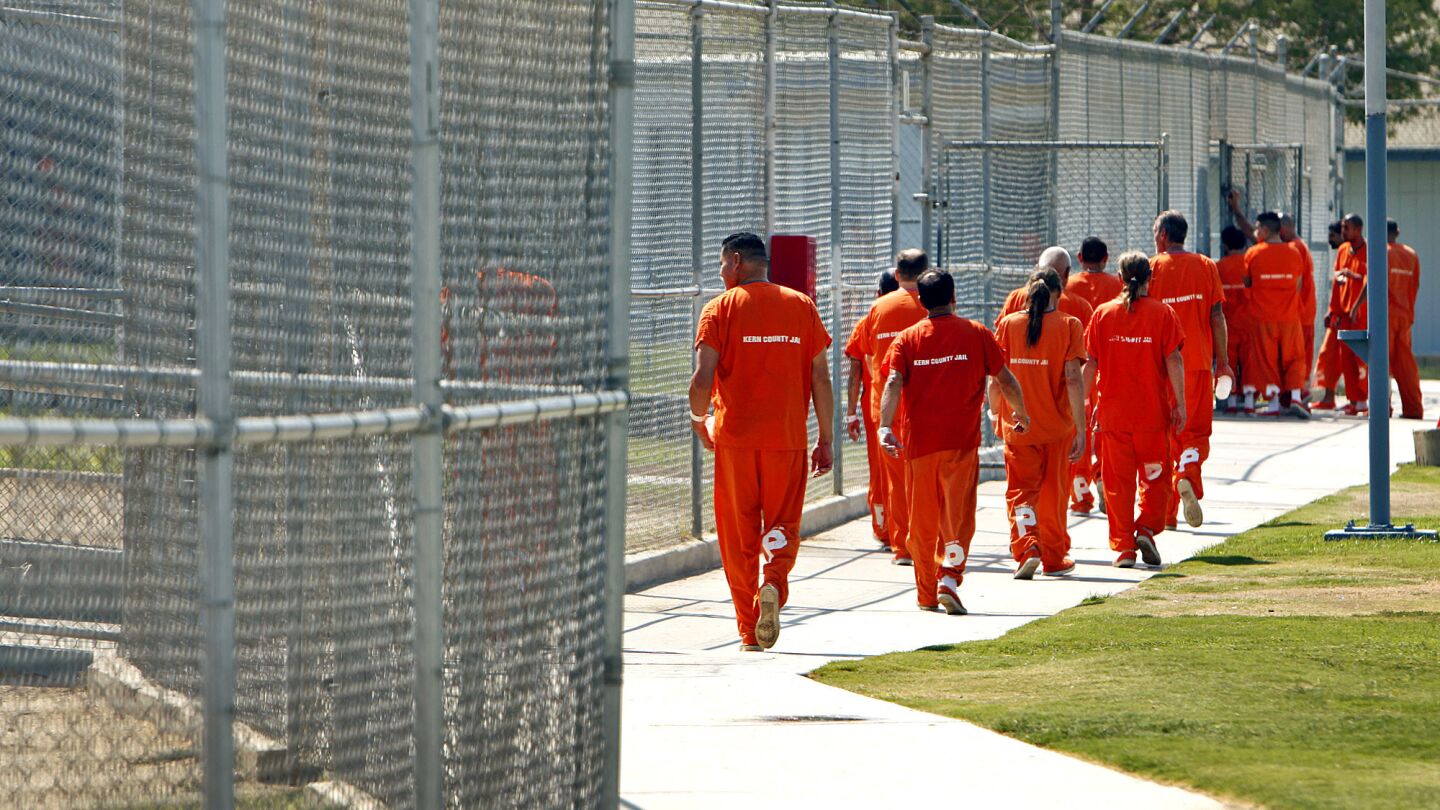 Inmates walk through the yard at the Kern County Sheriff's Department's Lerdo Detention Facility in Bakersfield. Because of the diversion of state prisoners, one Kern County jail reaches maximum capacity two or three times a week and must release 20 to 30 inmates to make room.