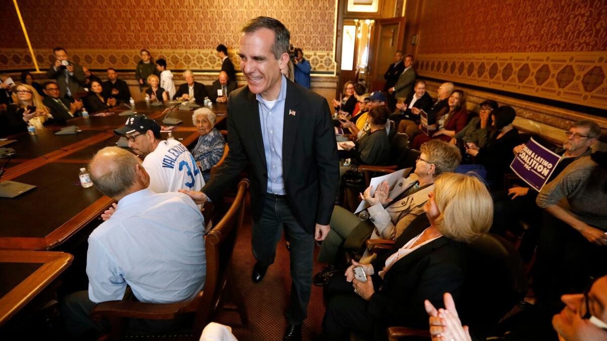 Los Angeles Mayor Eric Garcetti arrives at a meeting in Des Moines on April 13.