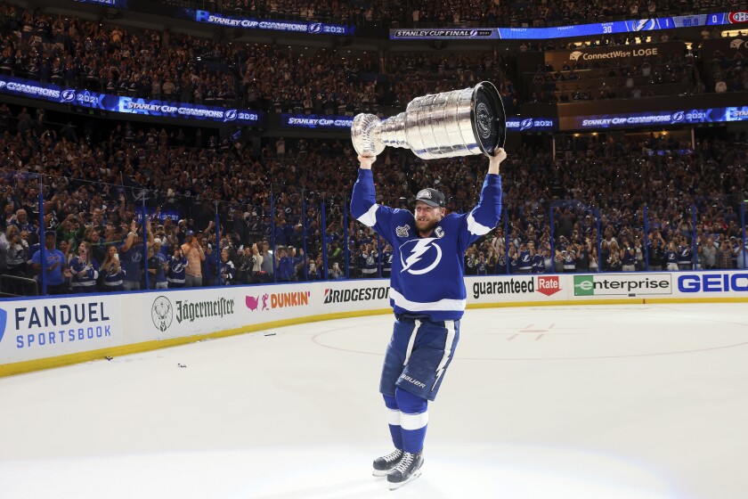 Tampa Bay Lightning's Steven Stamkos hoists the Stanley Cup after the team's 1-0 victory against the Montreal Canadiens in Game 5 of the NHL hockey Stanley Cup Finals, Wednesday, July 7, 2021, in Tampa, Fla. (Bruce Bennett/Pool Photo via AP)