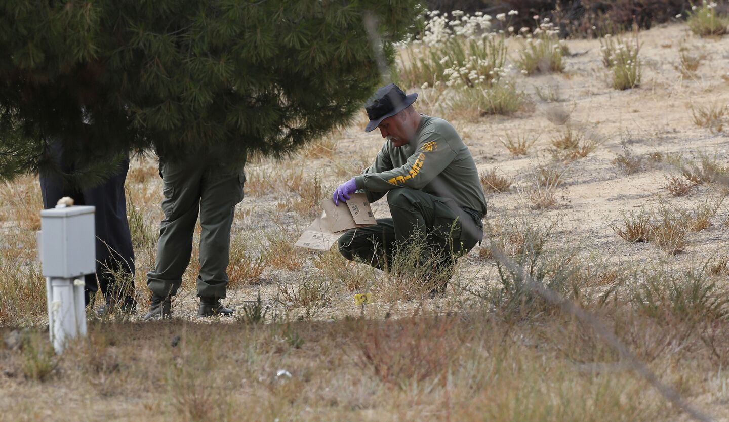 A Riverside County sheriff's investigator bags evidence at the Menifee home of 11-year-old Terry Dewayne Smith.
