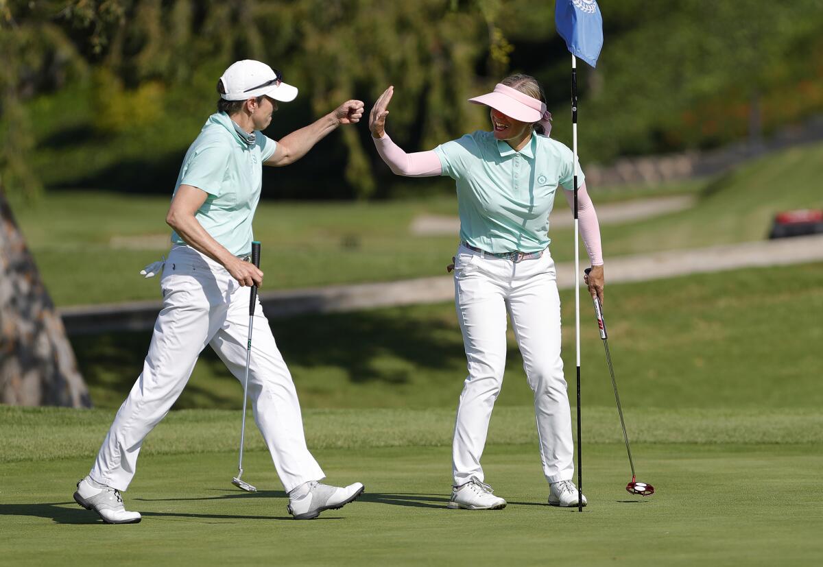 Mesa Verde ladies pro Kim Izzi, right, is congratulated after sinking a birdie putt during last year's Jones Cup.