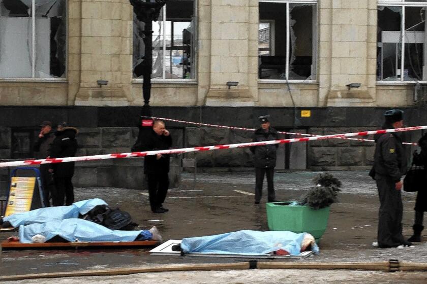Bodies of the bombing victims are covered outside the train station in Volgograd, Russia. The station was especially busy because bad weather had caused flights to be canceled at the city's airport.
