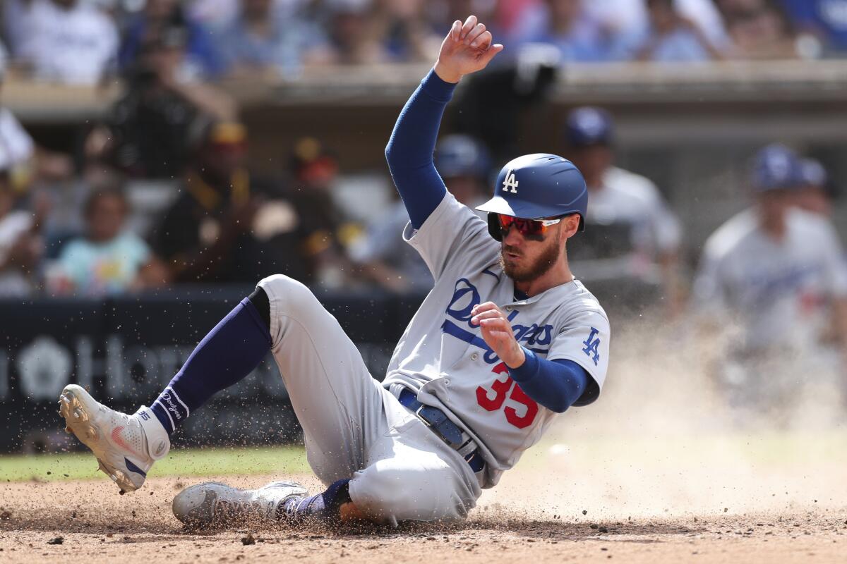 Dodgers baserunner Cody Bellinger scores against the San Diego Padres on Sunday.