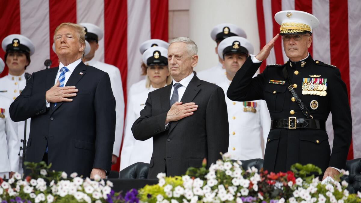 From left, President Trump, Secretary of Defense Jim Mattis and Chairman of the Joint Chiefs of Staff Gen. Joseph Dunford stand for taps during a Memorial Day ceremony.