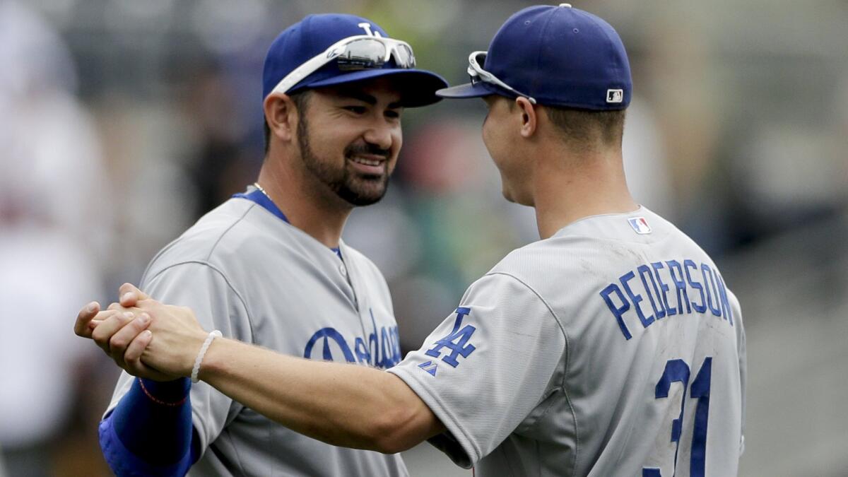 Dodgers teammates Adrian Gonzalez, left, and Joc Pederson celebrate the team's 4-2 win over the San Diego Padres on June 14, 2015.