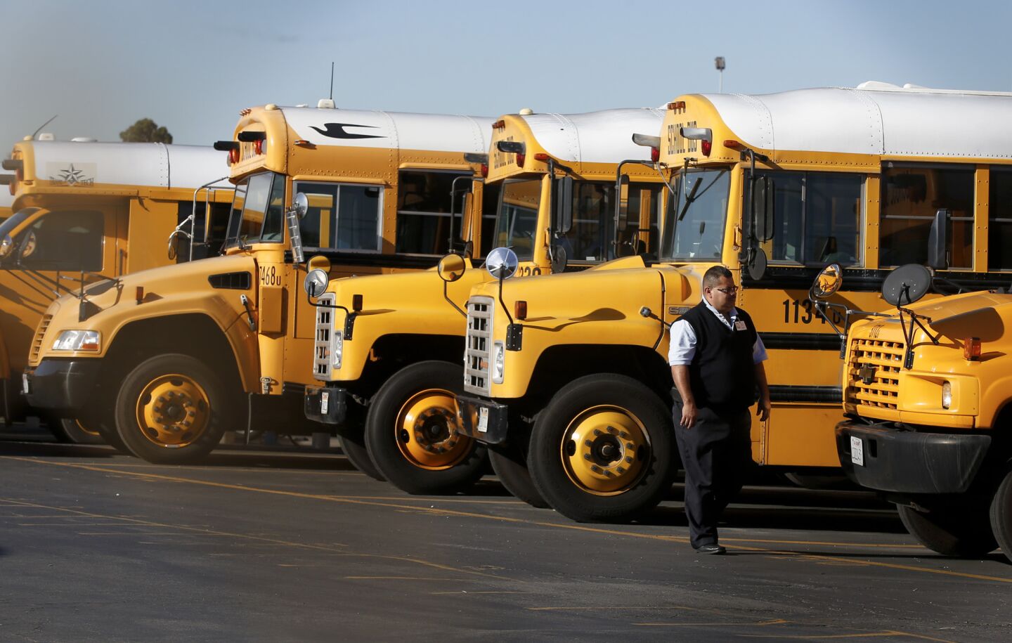School buses are idle in the LAUSD's Gardena garage after officials closed all campuses in the district following a "credible threat' of violence on Dec. 15.