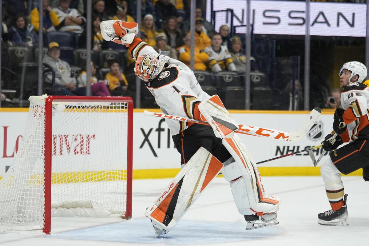 Ducks goaltender Lukas Dostal catches the puck as he defends the goal during the second period.