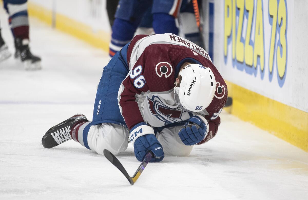 Colorado Avalanche's Mikko Rantanen (96) is injured after being hit by Edmonton Oilers' Mattias Ekholm during the second period of an NHL hockey game Friday, April 5, 2024, in Edmonton, Alberta. (Jason Franson/The Canadian Press via AP)