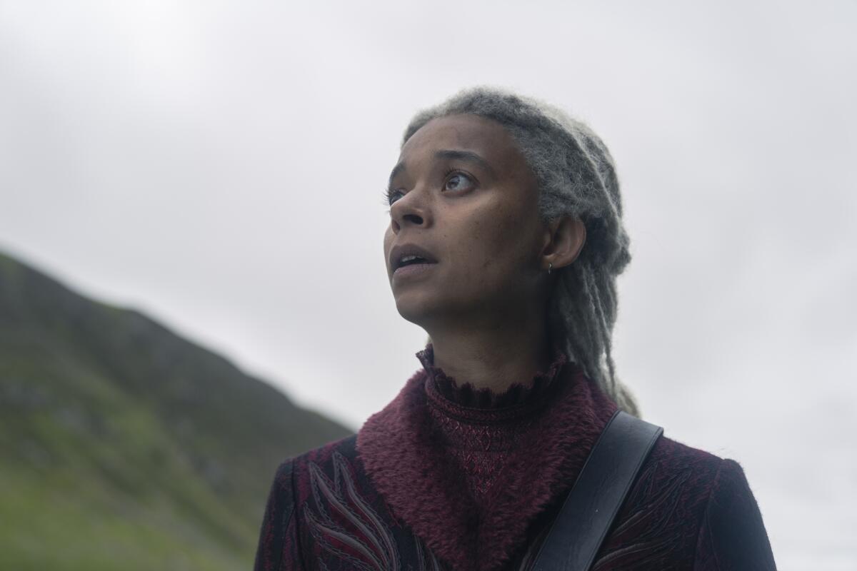 a woman with white hair looking upward