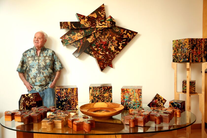 VENICE, CA - DECEMBER 23, 2022 - - 86-year-old marquetry artist William Tunberg stands next to a collection of his work in his home in Venice on December 22, 2022. (Genaro Molina / Los Angeles Times)