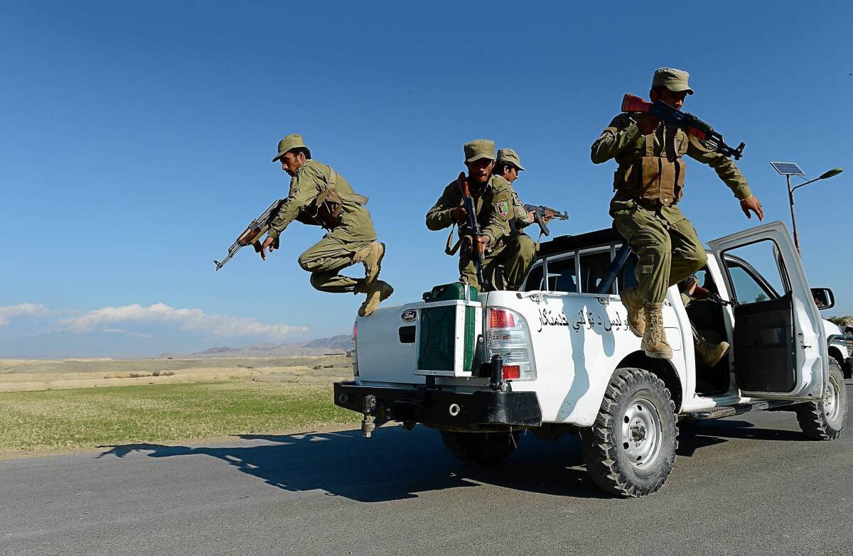 Afghan Local Police jump from their vehicle during a basic police training course in Nangarhar province.