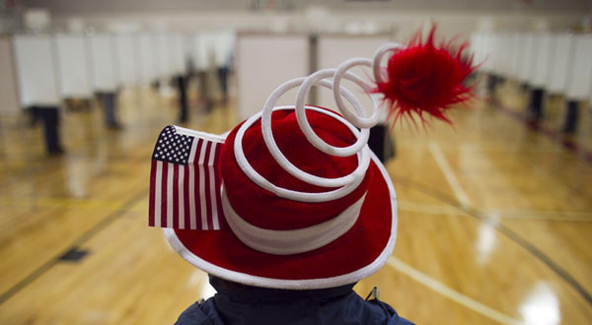 Susan Mardas celebrates Election Day by wearing a festive hat Tuesday while waiting for her mother to vote in Scarborough, Maine.