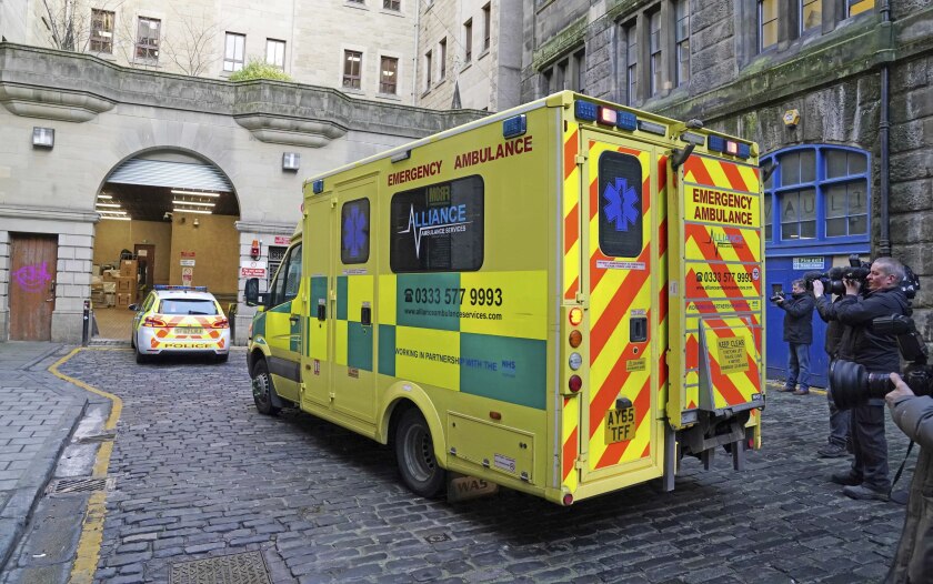 An ambulance thought to be carrying Nicholas Rossi, who is believed to have faked his own death to escape sex assault charges in Utah, United States, arrives at Sheriff Court in Edinburgh, Britain, Friday, Jan. 21, 2022, following his arrest after he missed an extradition hearing on Thursday at the same court. (Andrew Milligan/PA via AP)