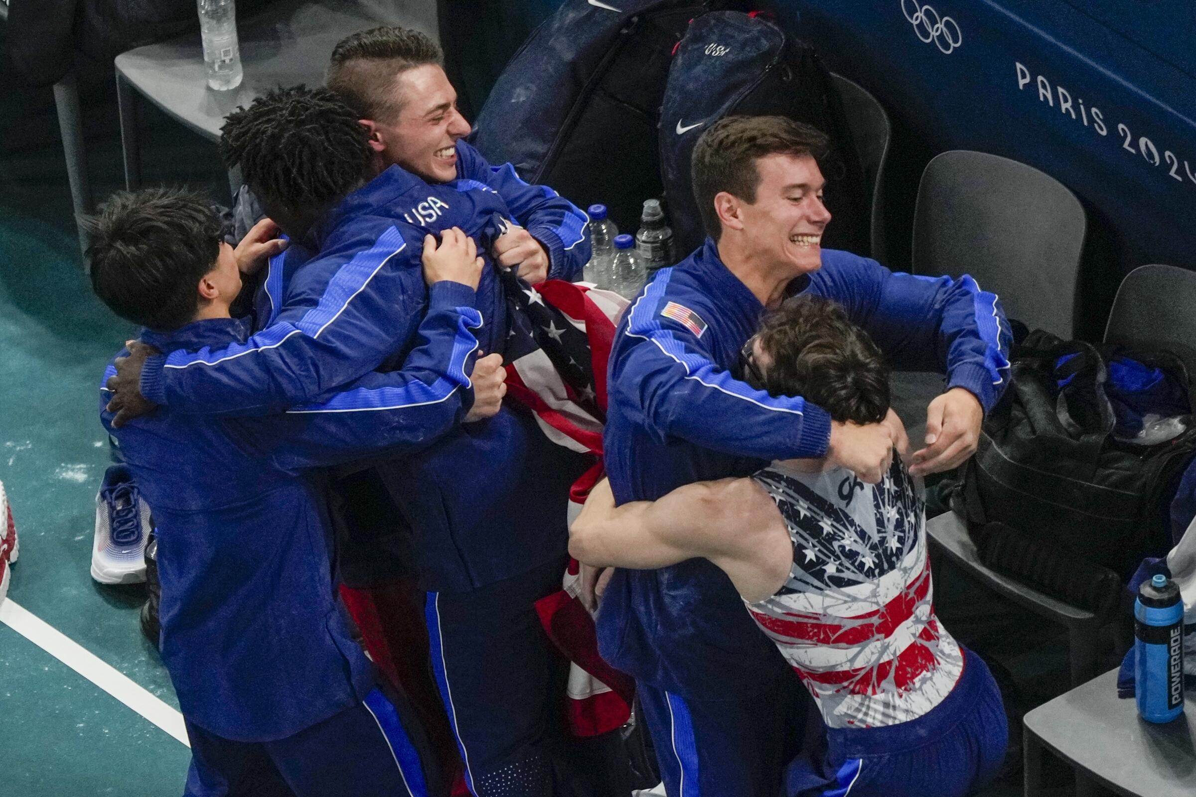 Members of the U.S. team hug after winning the bronze medal during the Olympic men's gymnastics team finals.