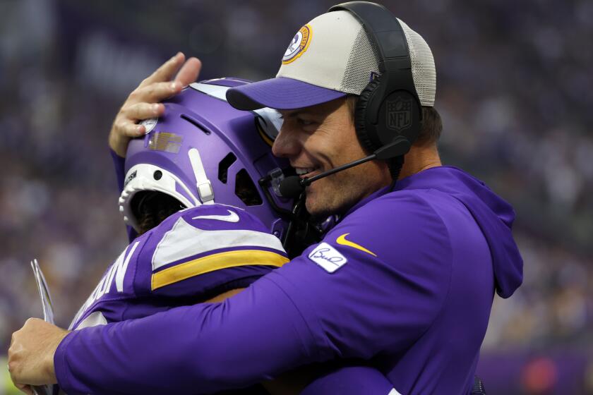 Minnesota Vikings wide receiver Justin Jefferson, left, celebrates with head coach Kevin O'Connell after catching a 52-yard touchdown pass during the second half of an NFL football game against the Los Angeles Chargers, Sunday, Sept. 24, 2023, in Minneapolis. (AP Photo/Bruce Kluckhohn)