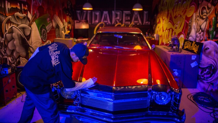 Jose Americo Crippa polishes his car during a gathering of lowrider enthusiasts in Sao Paulo, Brazil.