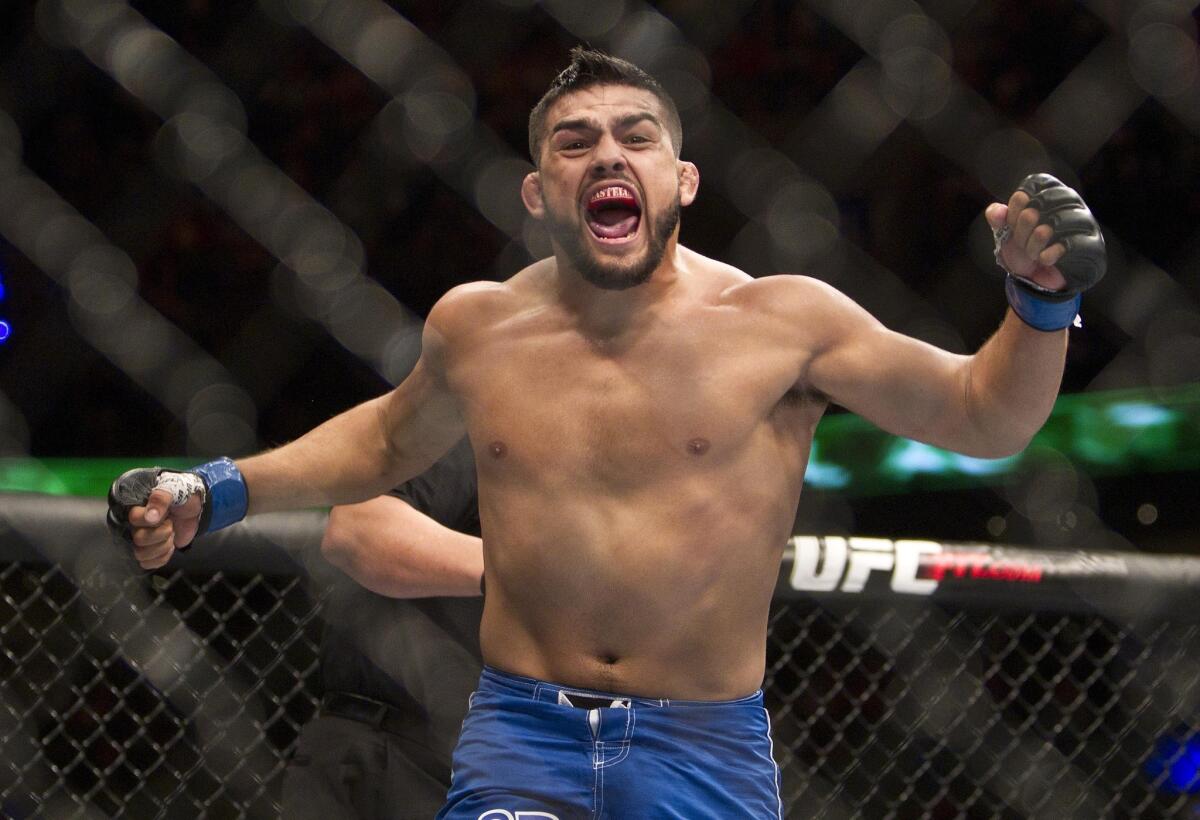 Kelvin Gastelum celebrates after defeating Jake Ellenberger by submission Saturday at UFC 180 in Mexico City.
