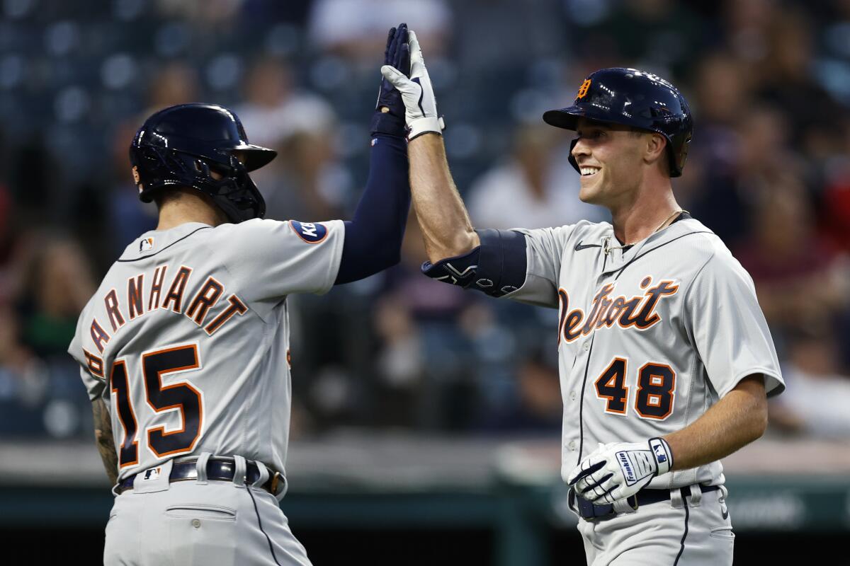 Detroit Tigers' Kerry Carpenter (48) celebrates with Tucker Barnhart after hitting a solo home run off Cleveland Guardians relief pitcher Eli Morgan during the sixth inning in the second baseball game of a doubleheader Monday, Aug. 15, 2022, in Cleveland. (AP Photo/Ron Schwane)