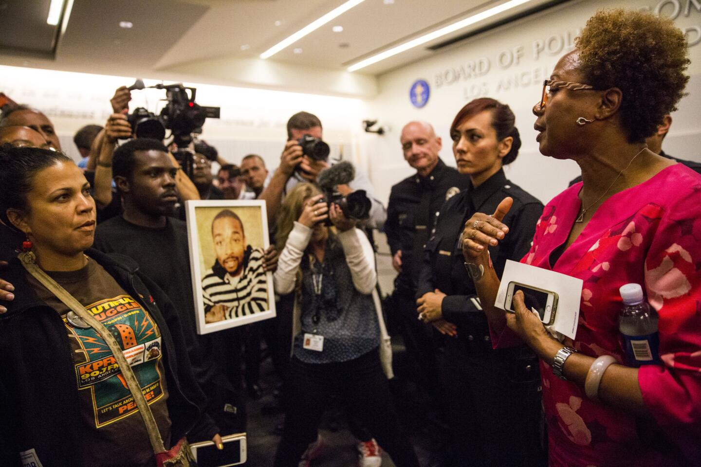 Police Commissioner Paula Madison, right, speaks with protesters at LAPD headquarters, explaining the commission's ruling on last year's shooting death of Ezell Ford.