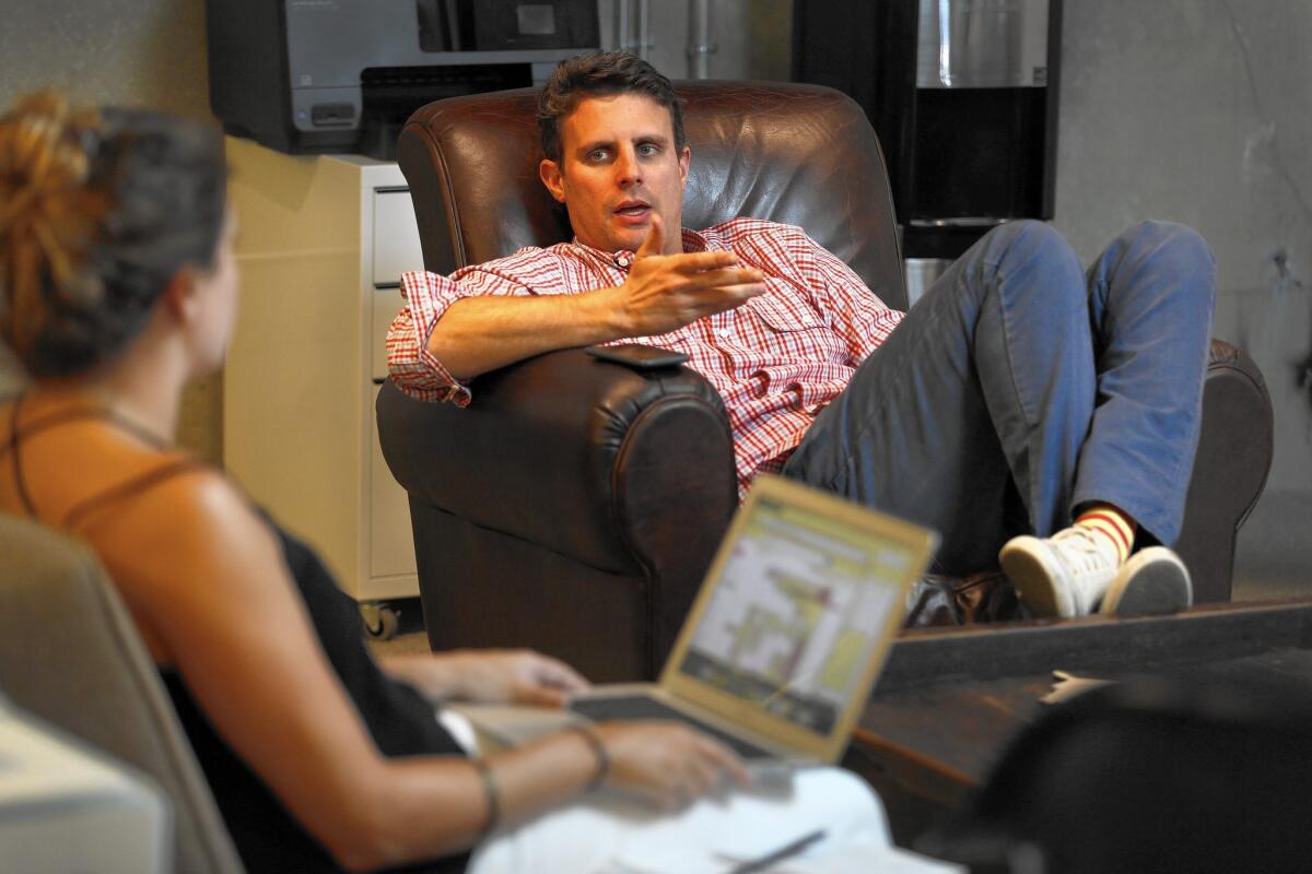 Dollar Shave Club chief Mike Dubin, center, talks with his assistant in his office. Dollar Shave Club has doubled its membership in less than 10 months.