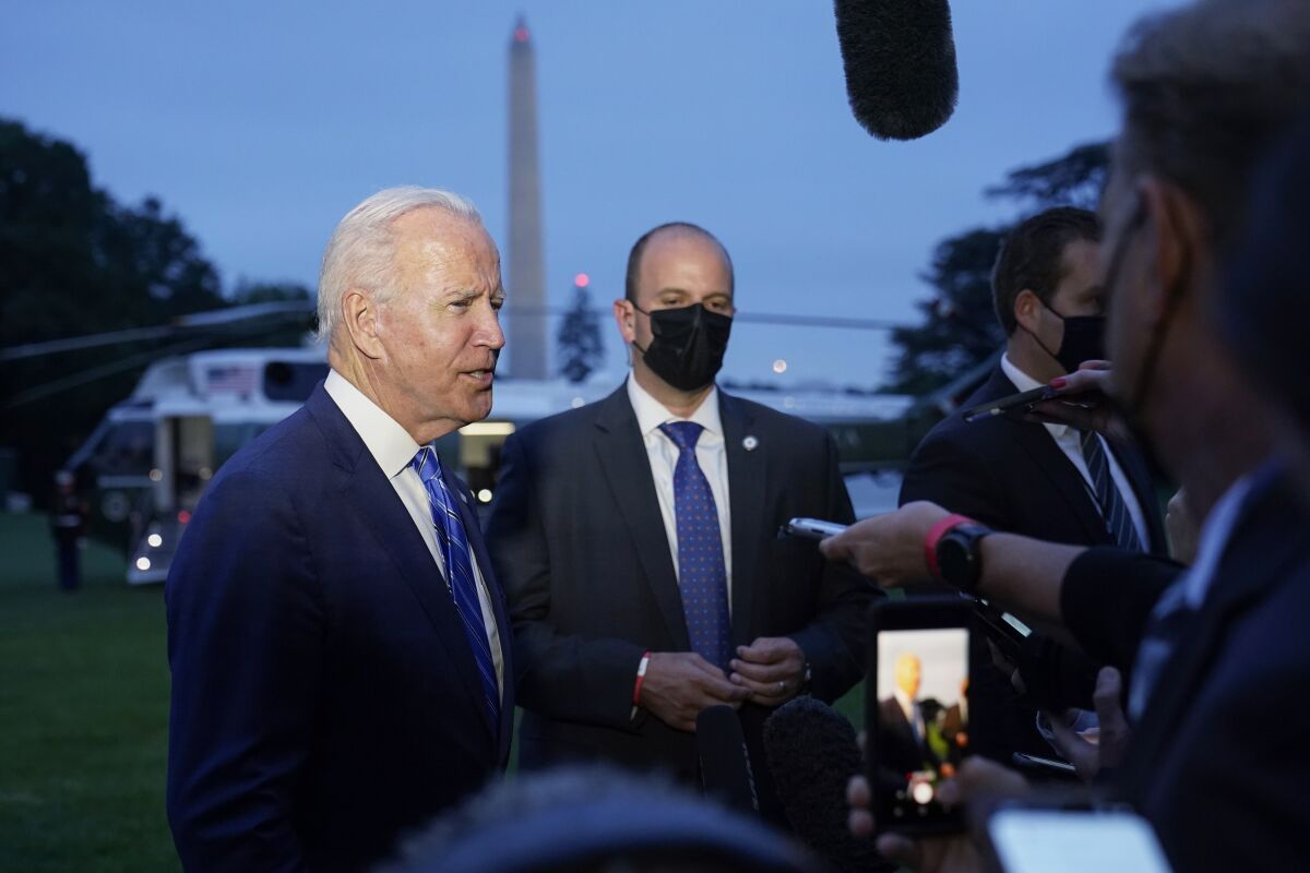 President Joe Biden talks with reporters.