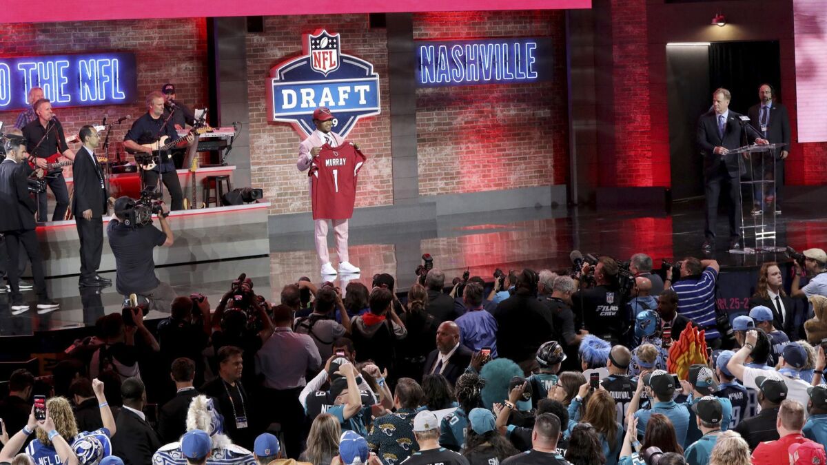 Kyler Murray with a jersey after being selected by the Arizona Cardinals with the first pick of the NFL draft April 25 in Nashville.