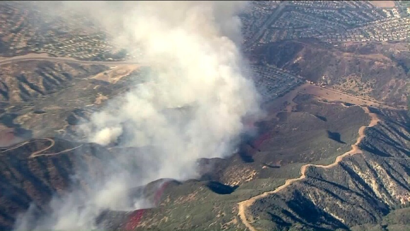 Crews battle a brush fire west of Corona, near the Cleveland National Forest.