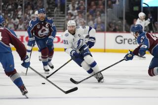 Tampa Bay Lightning center Steven Stamkos (91) controls the puck during the first period in Game 2 of the the team's NHL hockey Stanley Cup Final against the Colorado Avalanche, Saturday, June 18, 2022, in Denver. (AP Photo/John Locher)