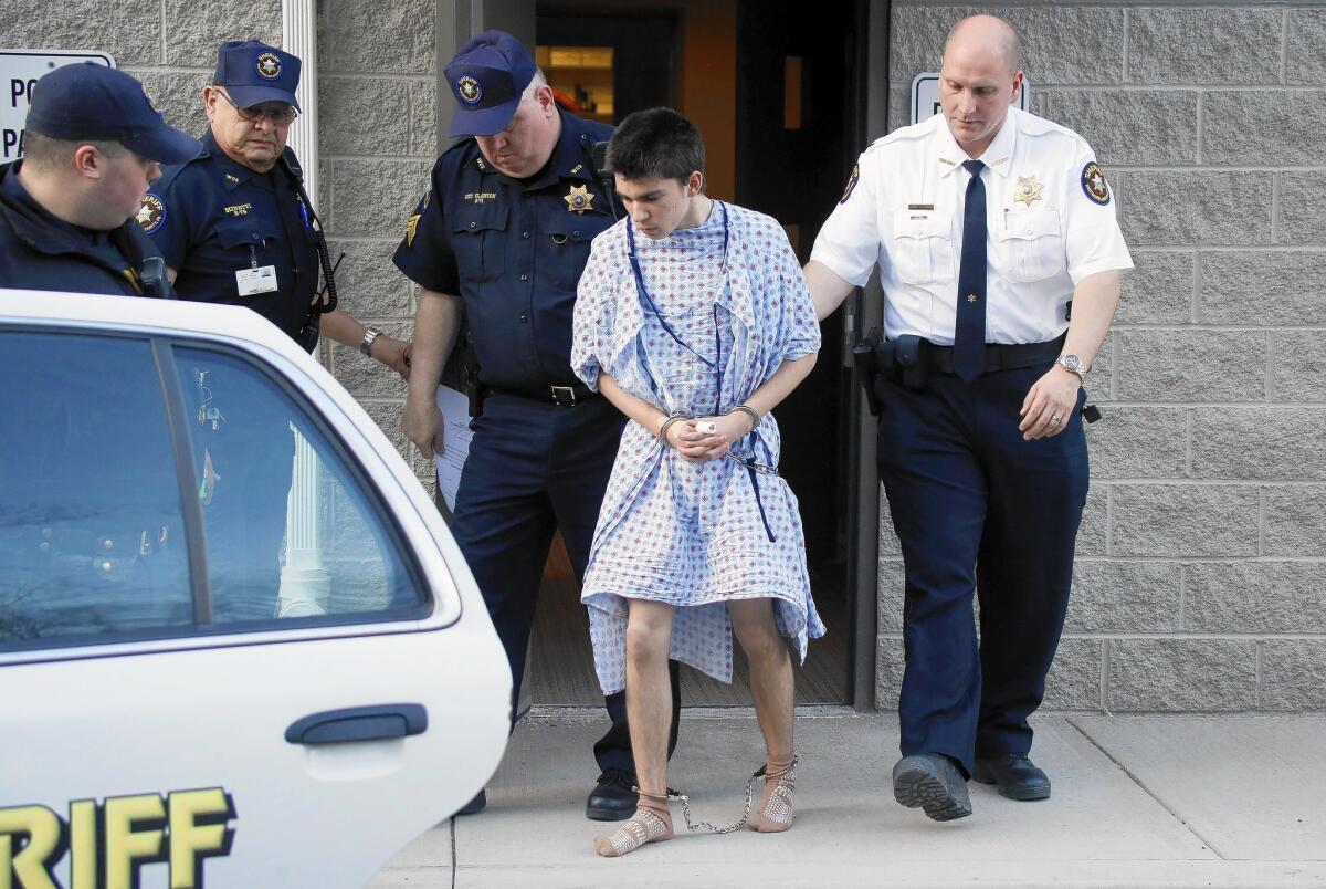 Suspect Alex Hribal, 16, is escorted from a courtroom.