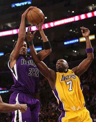 Sacramento Kings Mikki Moore, left, fights for the ball with Lakers Lamar Odom Friday night.