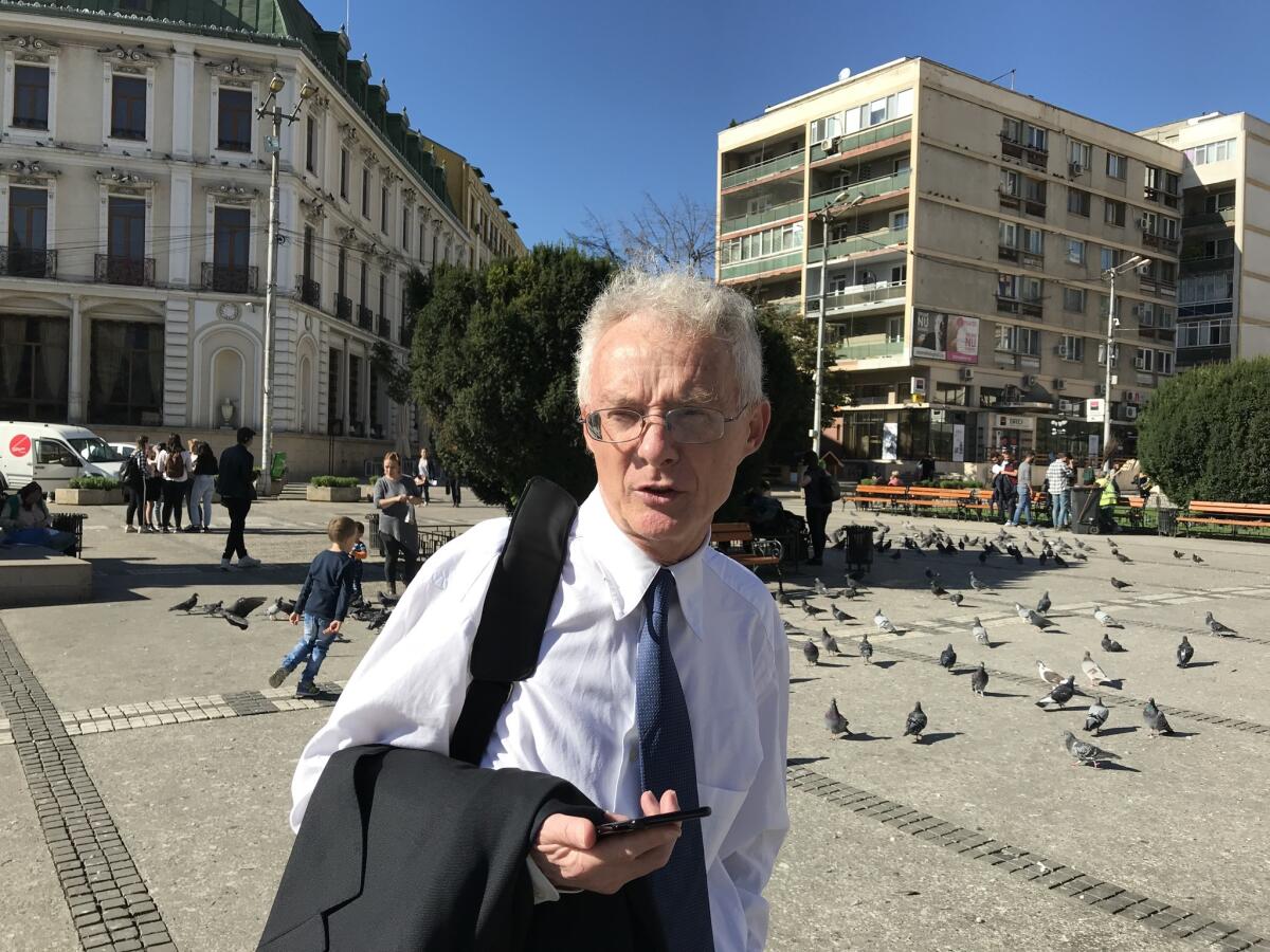 Peter Costea, a Texas-based labor lawyer, walks through a square in Iasi, Romania, to urge voters to participate in a referendum Saturday proposing a constitutional change to define marriage as a union between a man and a woman.