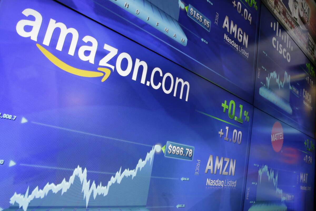 FILE - In this Tuesday, May 30, 2017, file photo, the Amazon logo is displayed at the Nasdaq Market Site, in New York's Times Square. Germany’s finance minister on Wednesday welcomed an agreement requiring large companies in the European Union to reveal how much tax they paid in which country. The deal was struck late Tuesday between representatives of the EU’s 27 member states and the European Parliament. (AP Photo/Richard Drew, File)