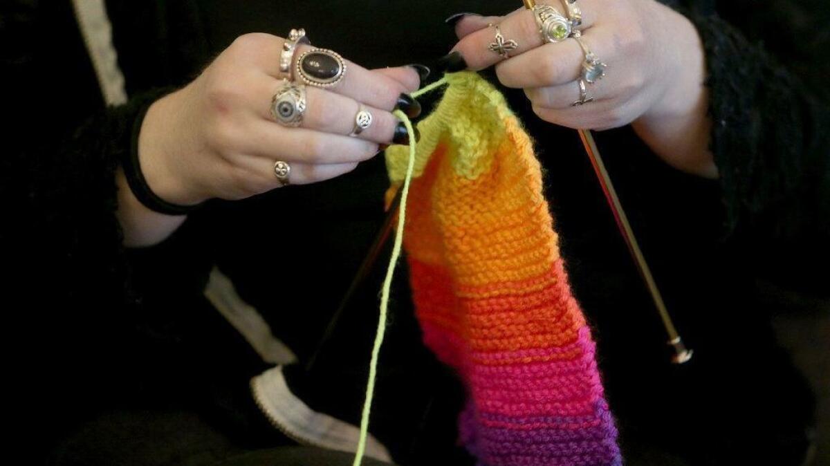 A woman knits in Silverdale, Wash., last year.