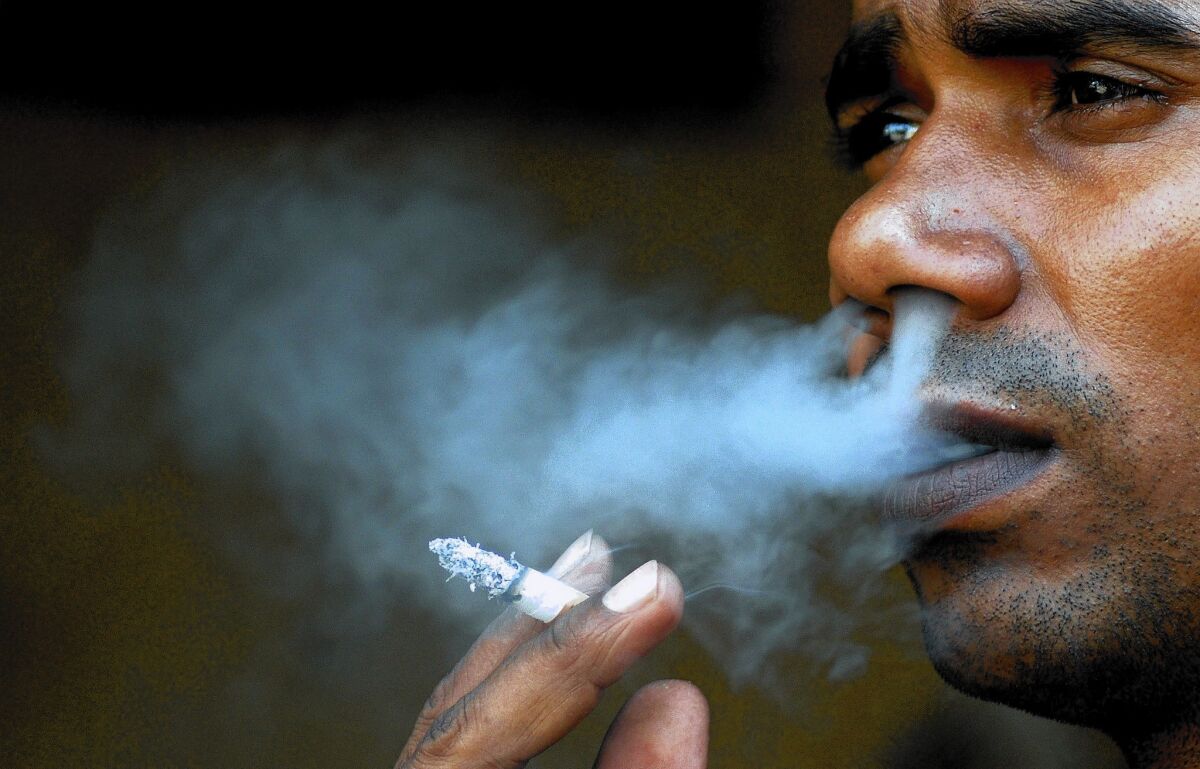 An Indian man smokes a cigarette on "World No Tobacco Day" in Mumbai.