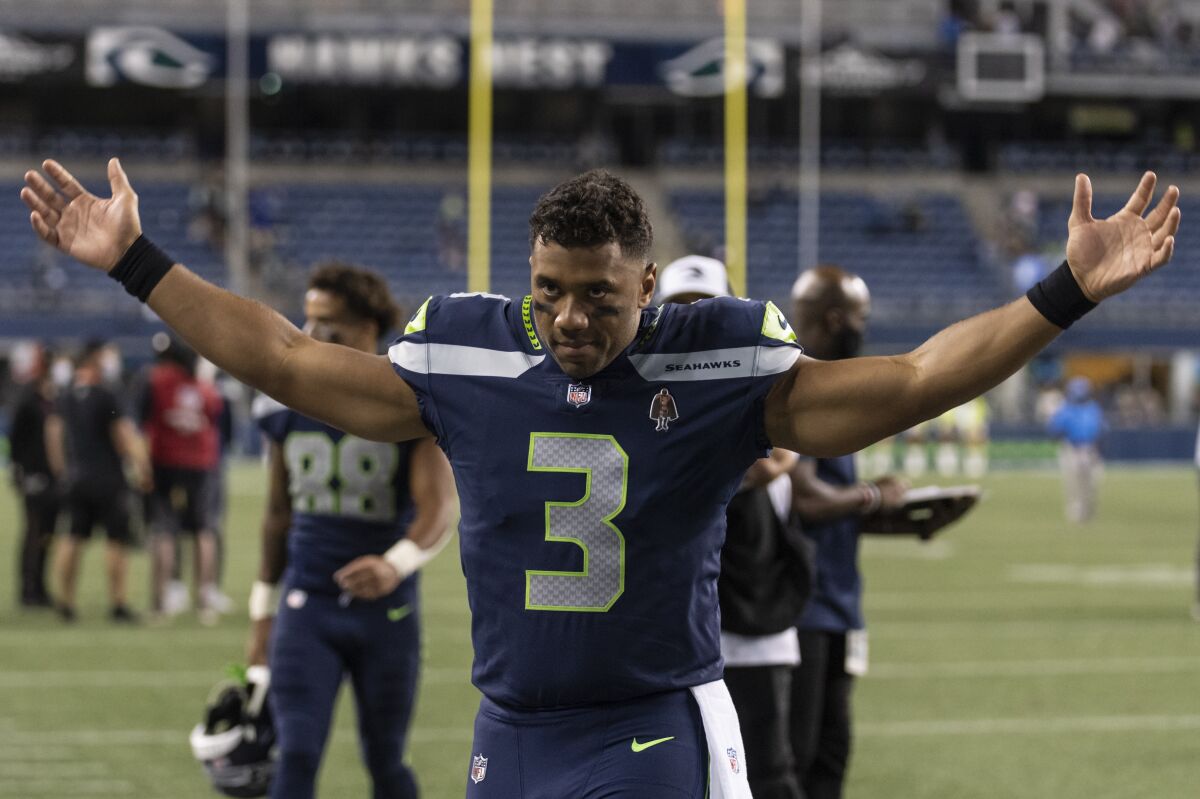 FILE - Seattle Seahawks quarterback Russell Wilson gestures as he walks off the field after an NFL preseason football game against the Los Angeles Chargers, Saturday, Aug. 28, 2021, in Seattle. The Seahawks won 27-0. The Seattle Seahawks have agreed to trade nine-time Pro Bowl quarterback Russell Wilson to the Denver Broncos for a massive haul of draft picks and players, two people familiar with the negotiations confirmed to The Associated Press on Tuesday, March 8, 2022. The people spoke on condition of anonymity because the blockbuster trade, which is pending Wilson passing a physical, can't become official until the start of the new league year on March 16. (AP Photo/Stephen Brashear, File)