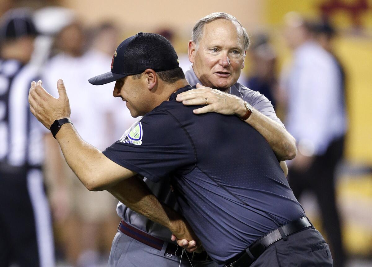 USC football coach Steve Sarkisian receives a hug from athletic director Pat Haden prior to the team's game against Arizona State in Tempe, Ariz. Sept. 26.