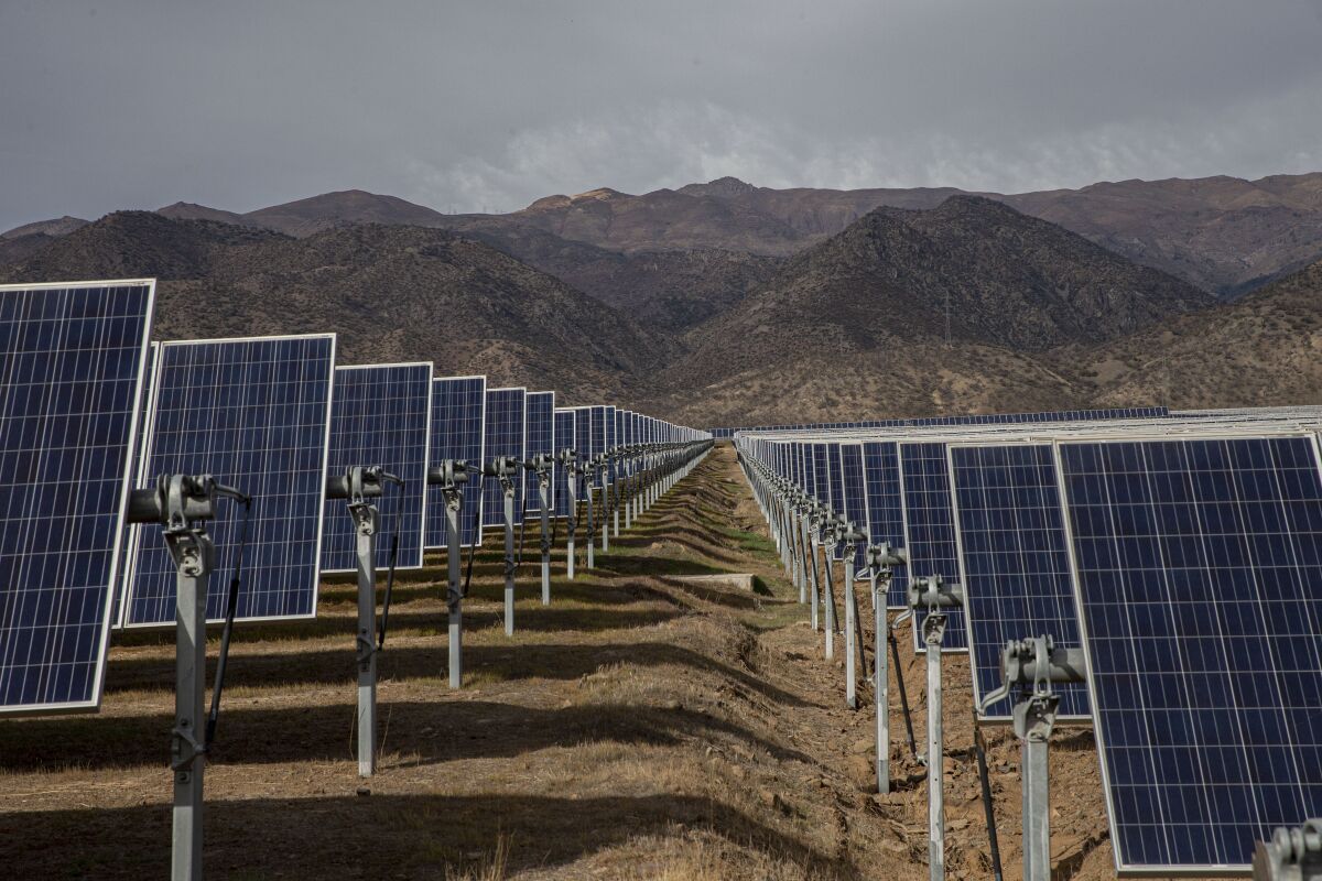 FILE - Solar panels stand in the Quilapilún solar energy plant, a joint venture by Chile and China, in Colina, Chile, Aug. 20, 2019. Chile has long held itself out as a global leader in the fight against climate change and now nearly 22% of Chile’s power is generated by solar and wind farms, putting it far ahead of both the global average, 10%. (AP Photo/Esteban Felix, File)