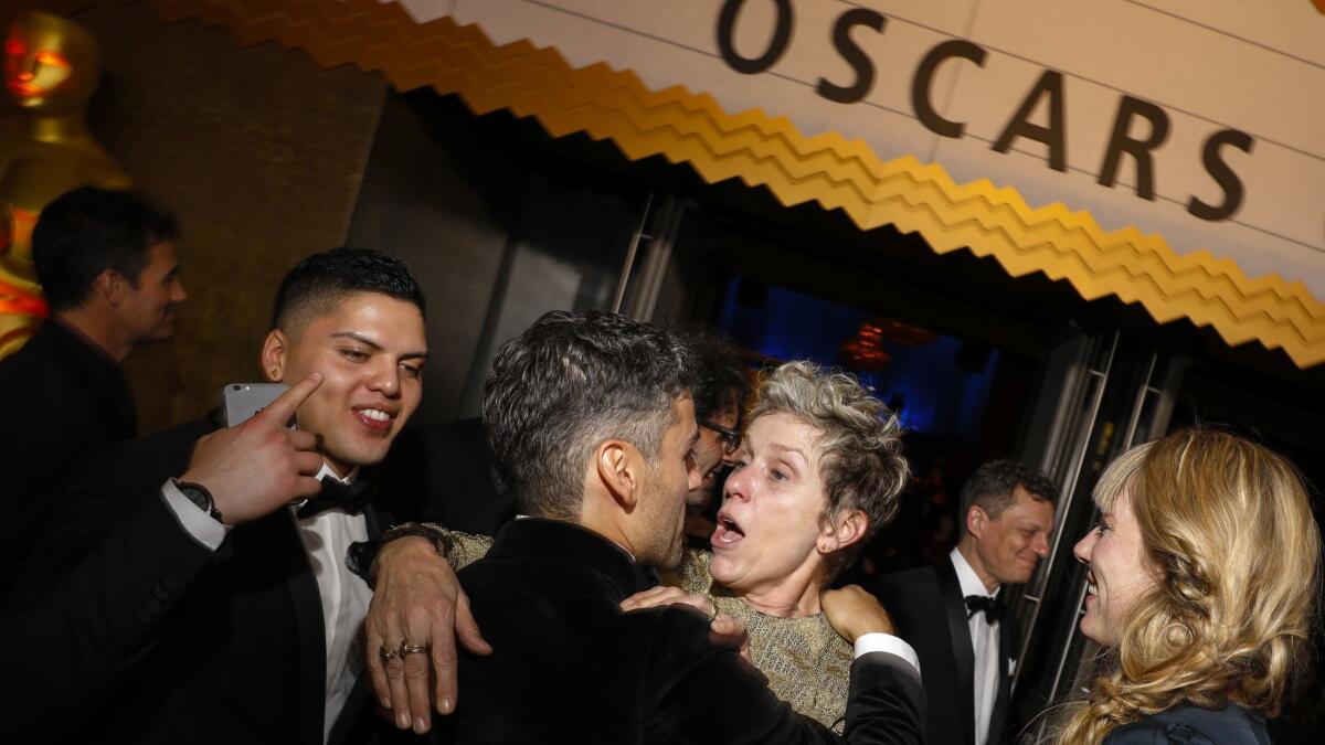 Frances McDormand talks with actor Oscar Isaac after her Academy Award for best actress went missing last year.